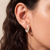 Small freshwater pearl hoop earrings on model 14k gold filled