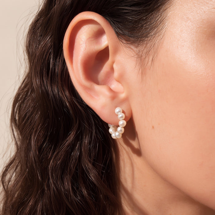 Small freshwater pearl hoop earrings on model 14k gold filled