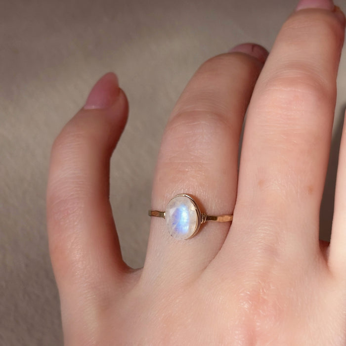 Blue flash moonstone floating oval wire wrapped ring gold filled on hand