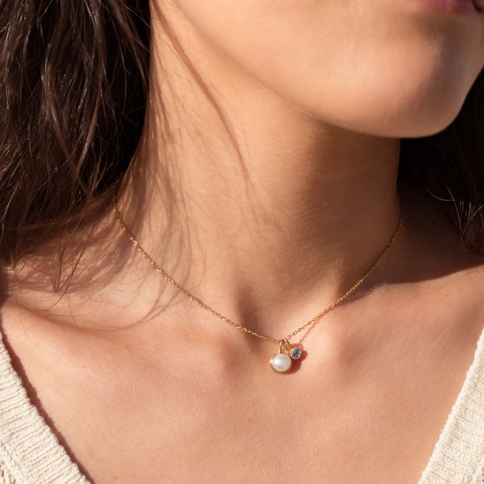 Dainty pearl and aquamarine two charm pendant necklace solid 14k gold on model