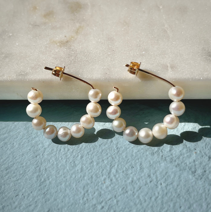 Freshwater pearl everyday minimalist gold filled small hoops on blue background