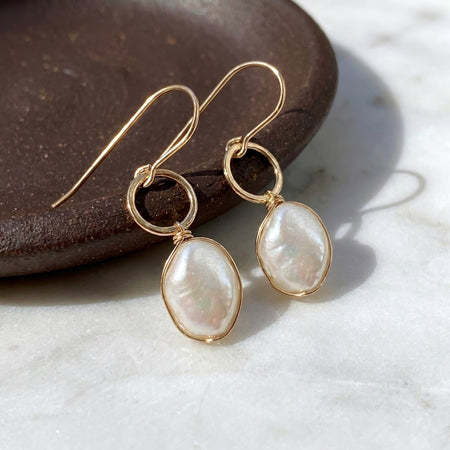 Chubby baroque pearl hammered gold filled drop earrings on brown ceramic dish