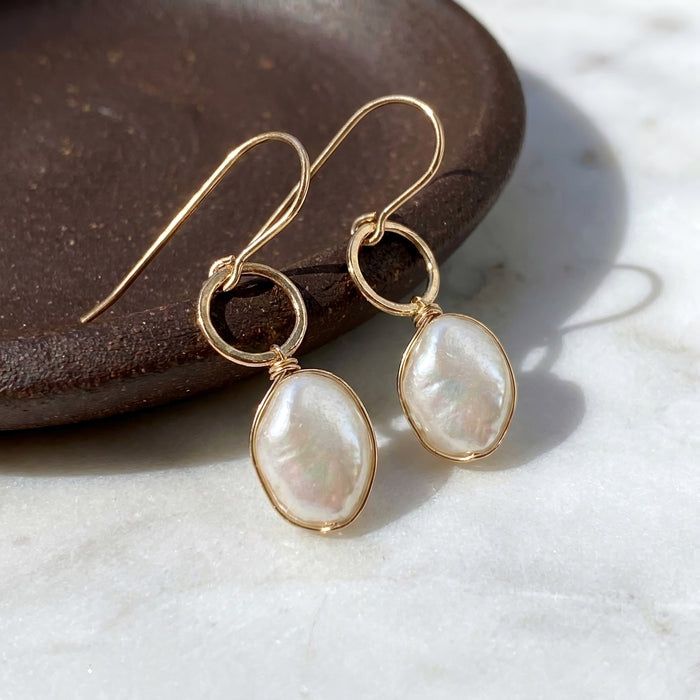 Chubby baroque pearl hammered gold filled drop earrings on brown ceramic dish