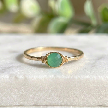 Dainty jade stacking ring gold filled on white marble background bright cool green rose cut jade wire wrapped setting