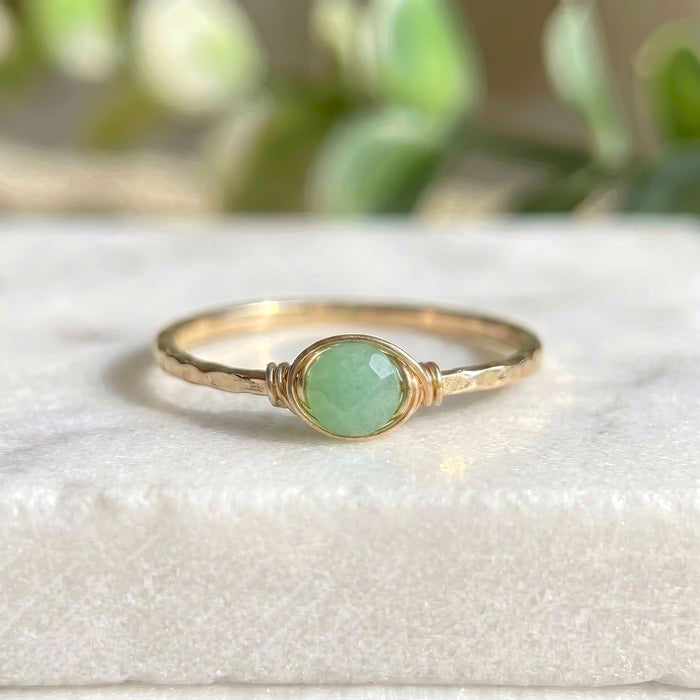 Dainty jade stacking ring gold filled on white marble background light green rose cut jade wire wrapped setting