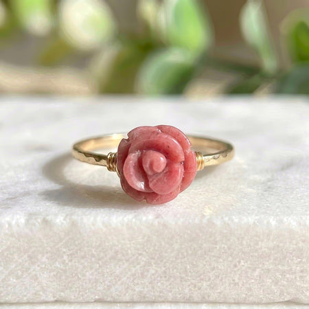 Pink carved crystal gold filled rose ring natural rhodochrosite on marble background