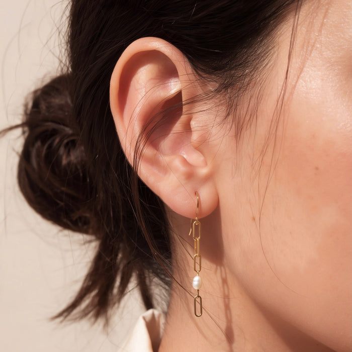Paperclip chain and pearl mismatched drop earrings on model 14k gold filled