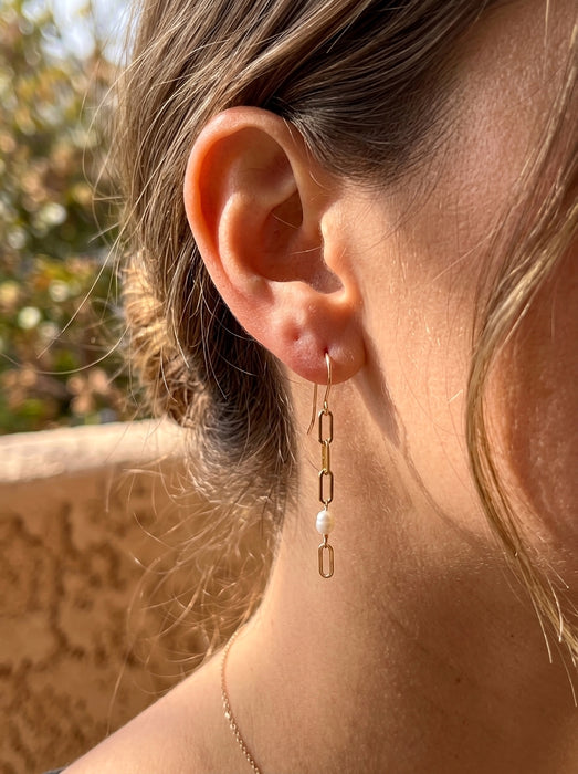 Asymmetrical paperclip chain freshwater pearl drop earrings gold filled on model