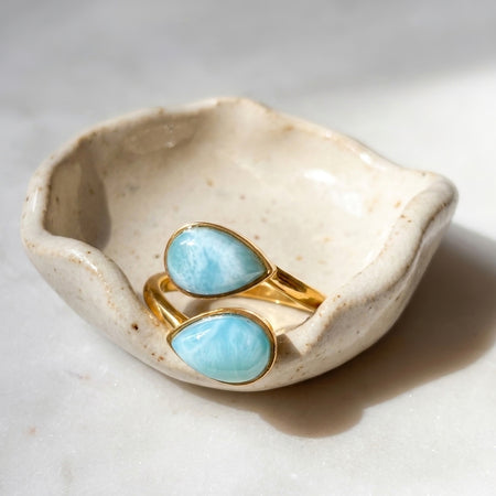 Gold larimar adjustable teardrop two stone ring on ceramic dish