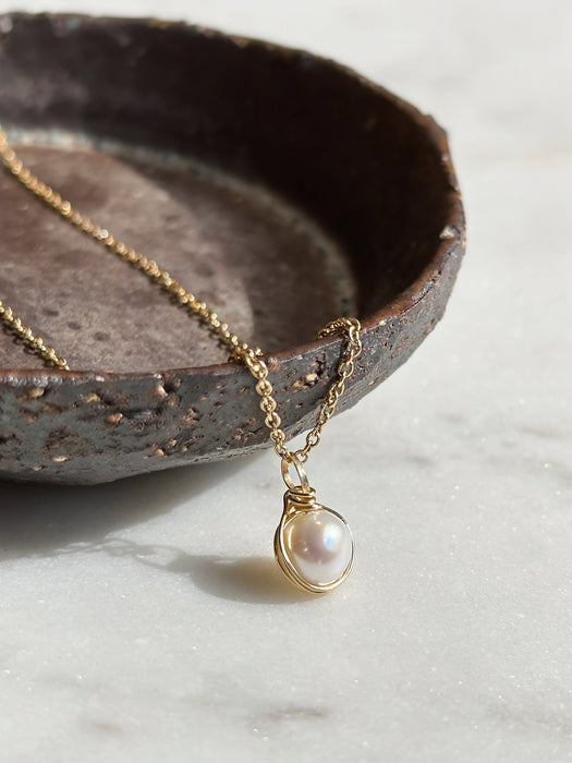 Dainty pearl charm pendant necklace solid 14k gold angle view
