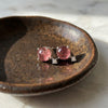 Sterling silver pink tourmaline celestial stud earrings with tiny clear topaz accent stones in ceramic jewelry dish
