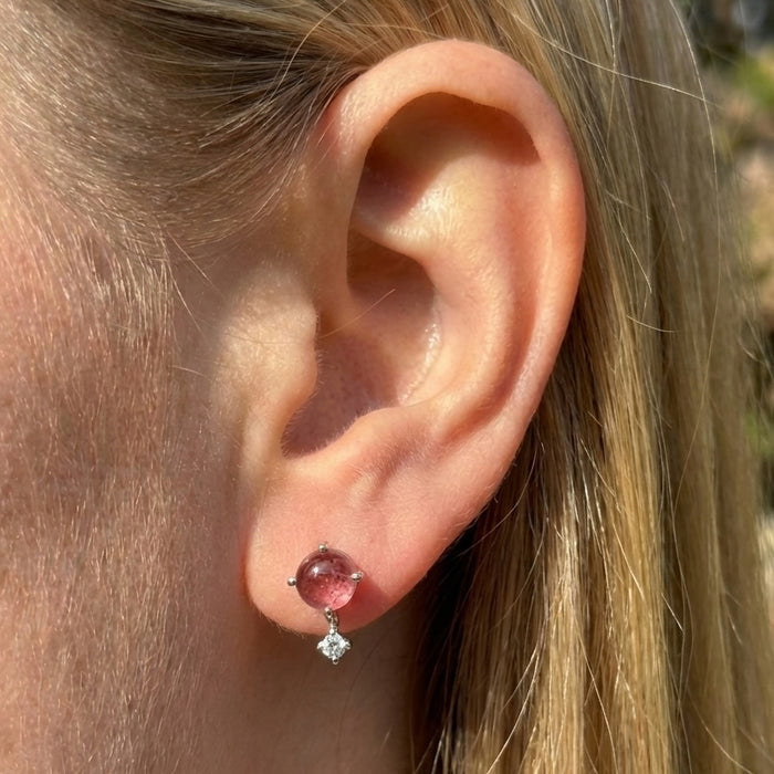 Sterling silver pink tourmaline celestial stud earrings with tiny clear topaz accent stones on model