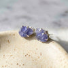 Raw tanzanite blue lavender statement stud earrings with raw natural crystals rough blue stone bold and colorful healing crystal stud earrings on ceramic jewelry dish