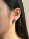 Raw tanzanite stud earrings sterling silver on model