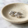 Vintage sterling silver rose stud earrings on ceramic jewelry dish