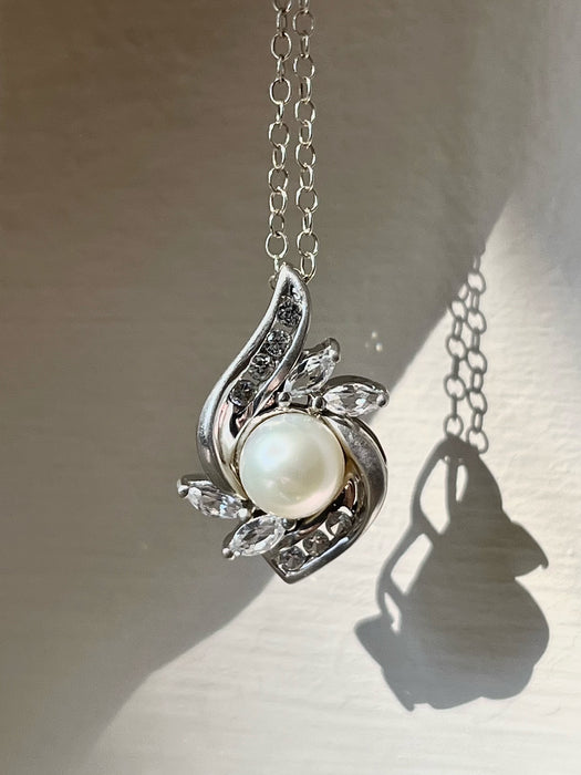 Vintage white sapphire and pearl cluster necklace sterling silver light background
